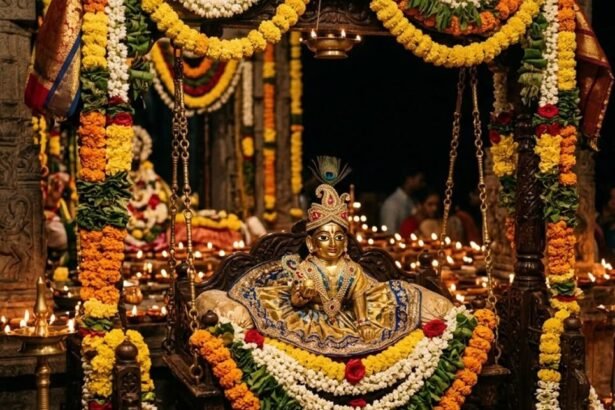 Beautifully decorated idol of baby Lord Krishna illuminated by diyas during the midnight Janmashtami puja.